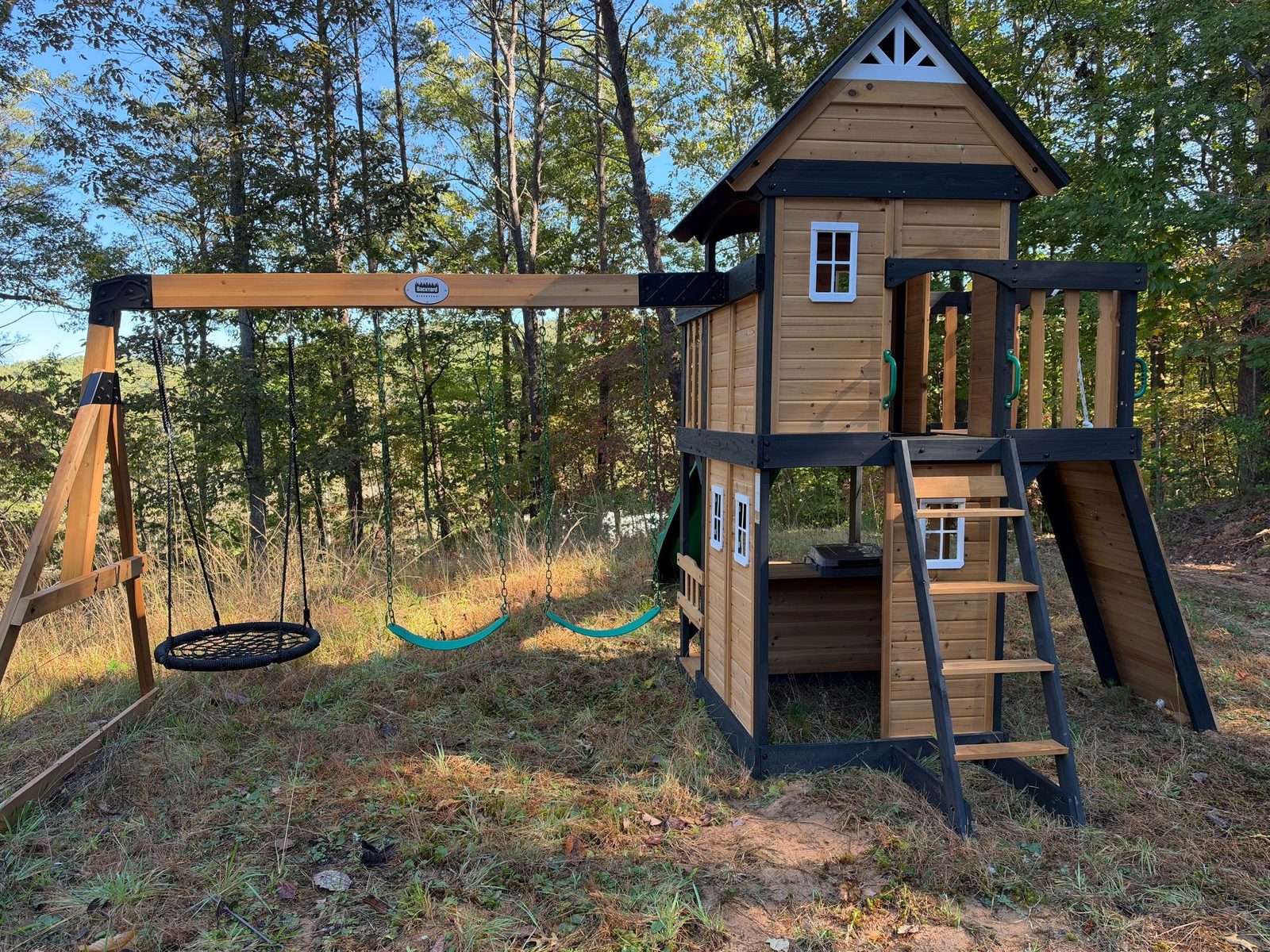 Cabin swing set and two-story clubhouse assembled in Blue Ridge, GA with nest swing and belt swings