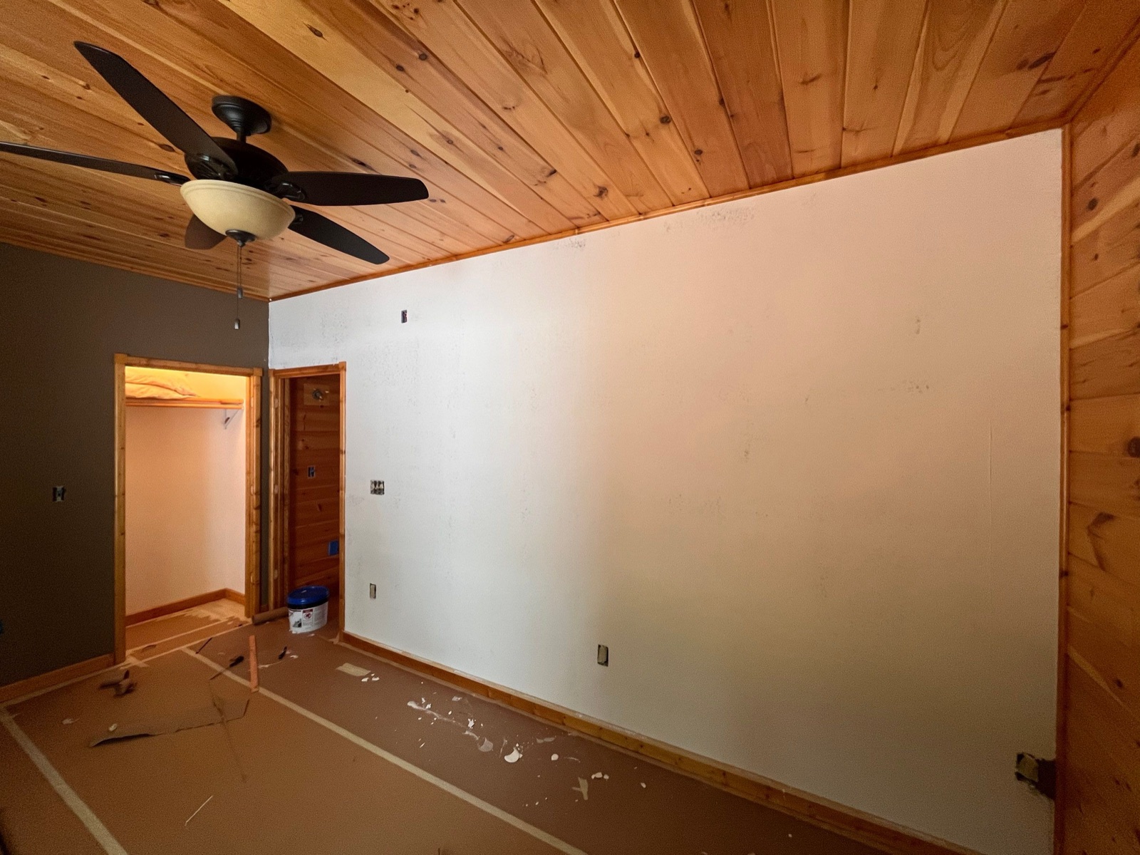 Cabin basement game room with a pool table and a red painted accent wall in North Georgia
