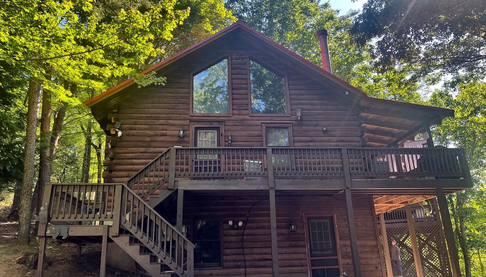 Back of a Cherry Log, GA log cabin with faded, weathered stain before restaining